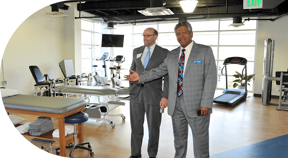 Doctor at CAO welcoming patients to their physical therapy appointment.