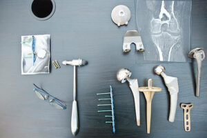 The desk of an orthopedic surgeon with different types of arthroplasties. Hip, shoulder, knee, philos plates...