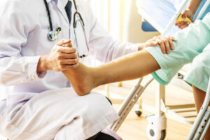 Doctor examining of the leg from the knee and ankle and training broken leg patient